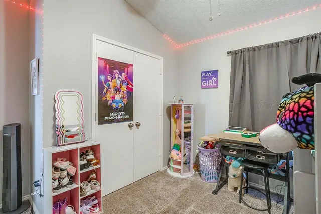 a bedroom with furniture and a fan