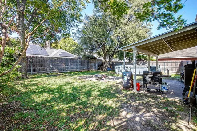 a view of a house with a backyard and a patio