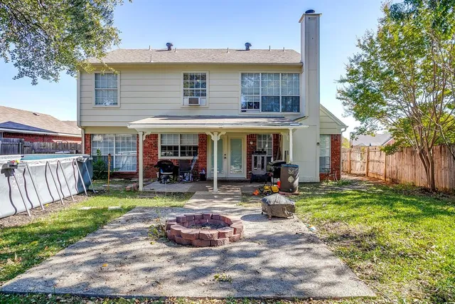 a view of a house with backyard sitting area and garden