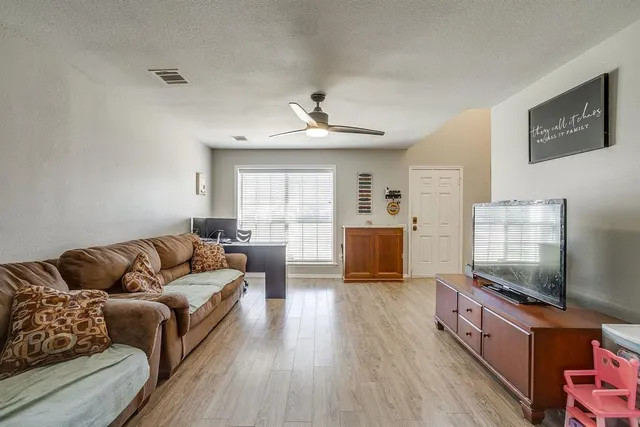 a living room with furniture and a flat screen tv