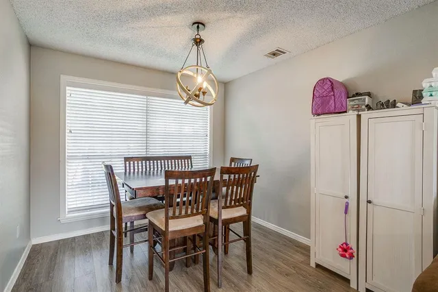 a view of a dining room with furniture wooden floor and chandelier