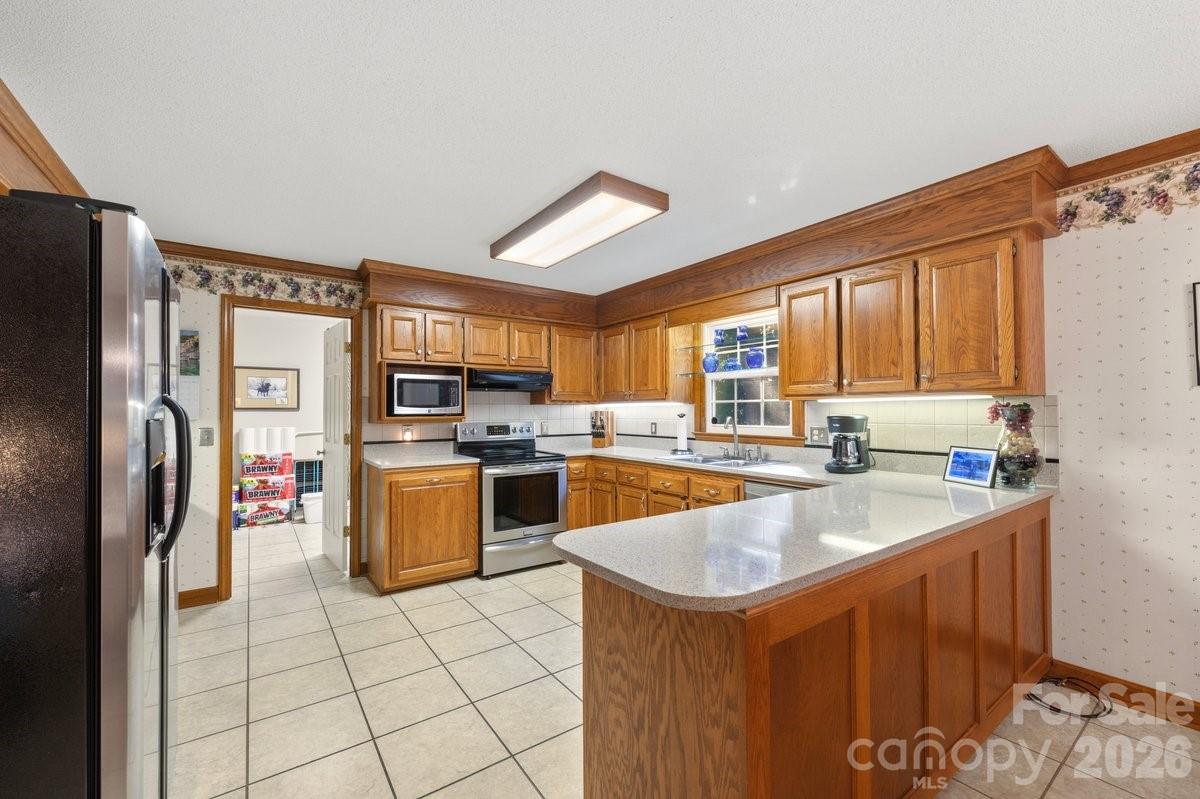 207 Lost Corner Road Morganton, NC 28655 - Photo 16 of 46 a kitchen with a refrigerator sink and stove