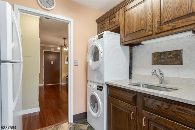 a utility room with a sink a washer and dryer