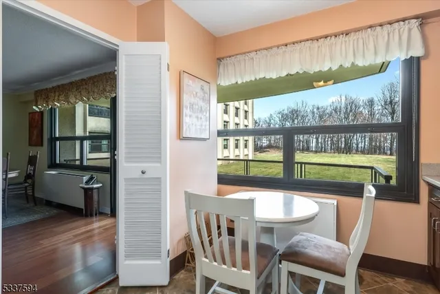 a dining room with furniture a rug and wooden floor