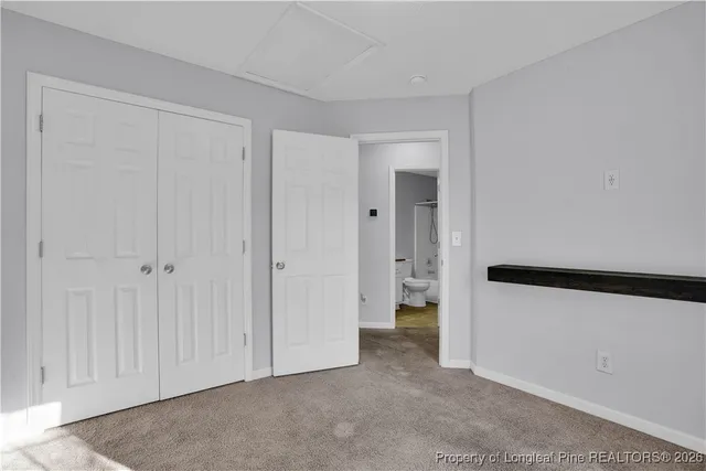a bathroom with a granite countertop sink and a toilet
