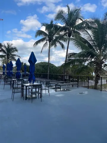 a view of a patio with dining table and chairs