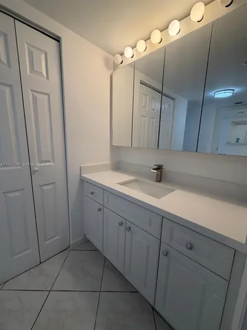 a spacious bathroom with a sink and a mirror