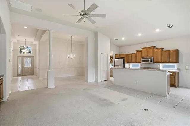 a view of a hallway with wooden cabinet and a living room