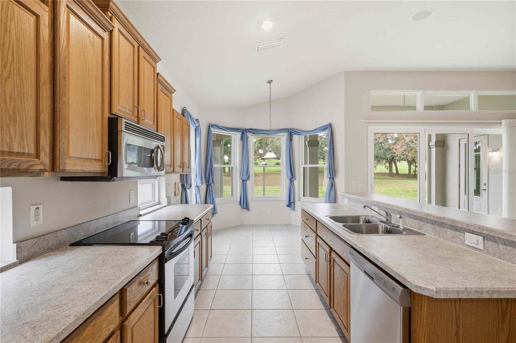680 West Doerr Path Hernando, FL 34442 - Photo 21 of 48 a large kitchen with stainless steel appliances granite countertop a sink and a stove