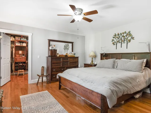 a bedroom with a bed and a television