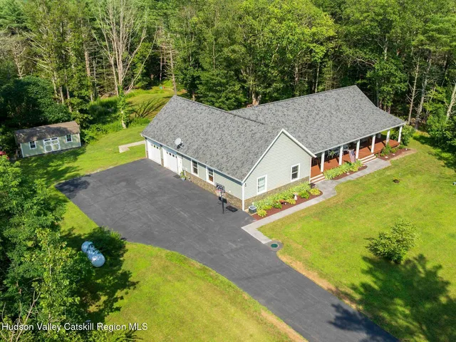 an aerial view of a house with swimming pool