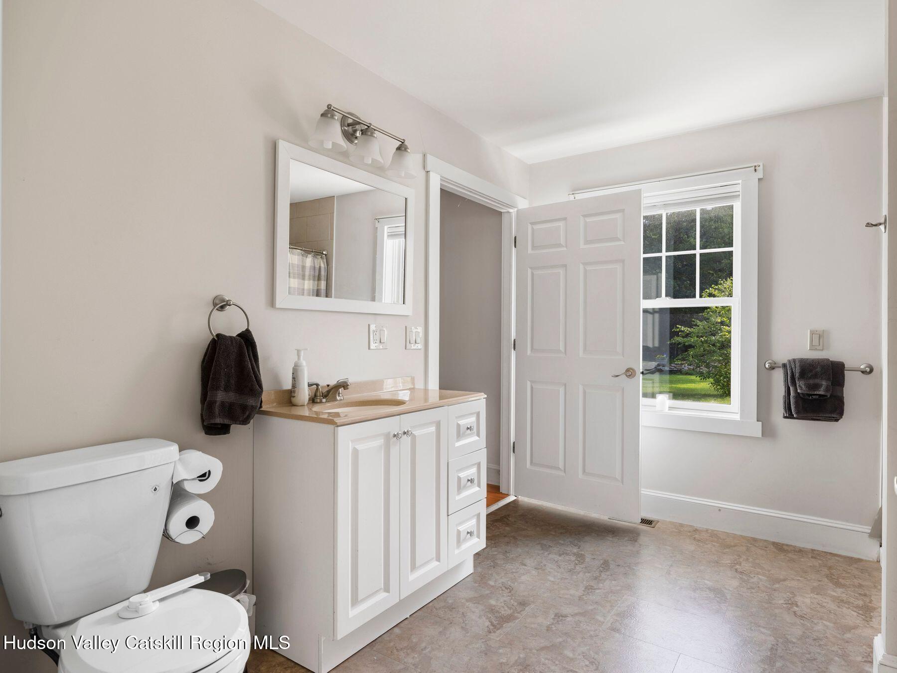 15 Pine Street Cairo, NY 12413 - Photo 34 of 46 a bathroom with a granite countertop toilet sink and mirror
