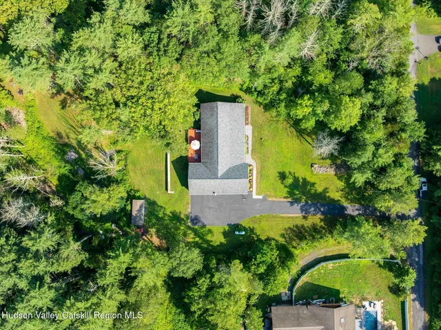 a view of a fire pit in a yard with large trees