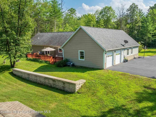 a aerial view of a house with a yard table and chairs