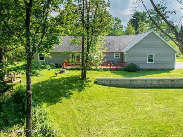 an aerial view of a house with a yard swimming pool outdoor seating and yard