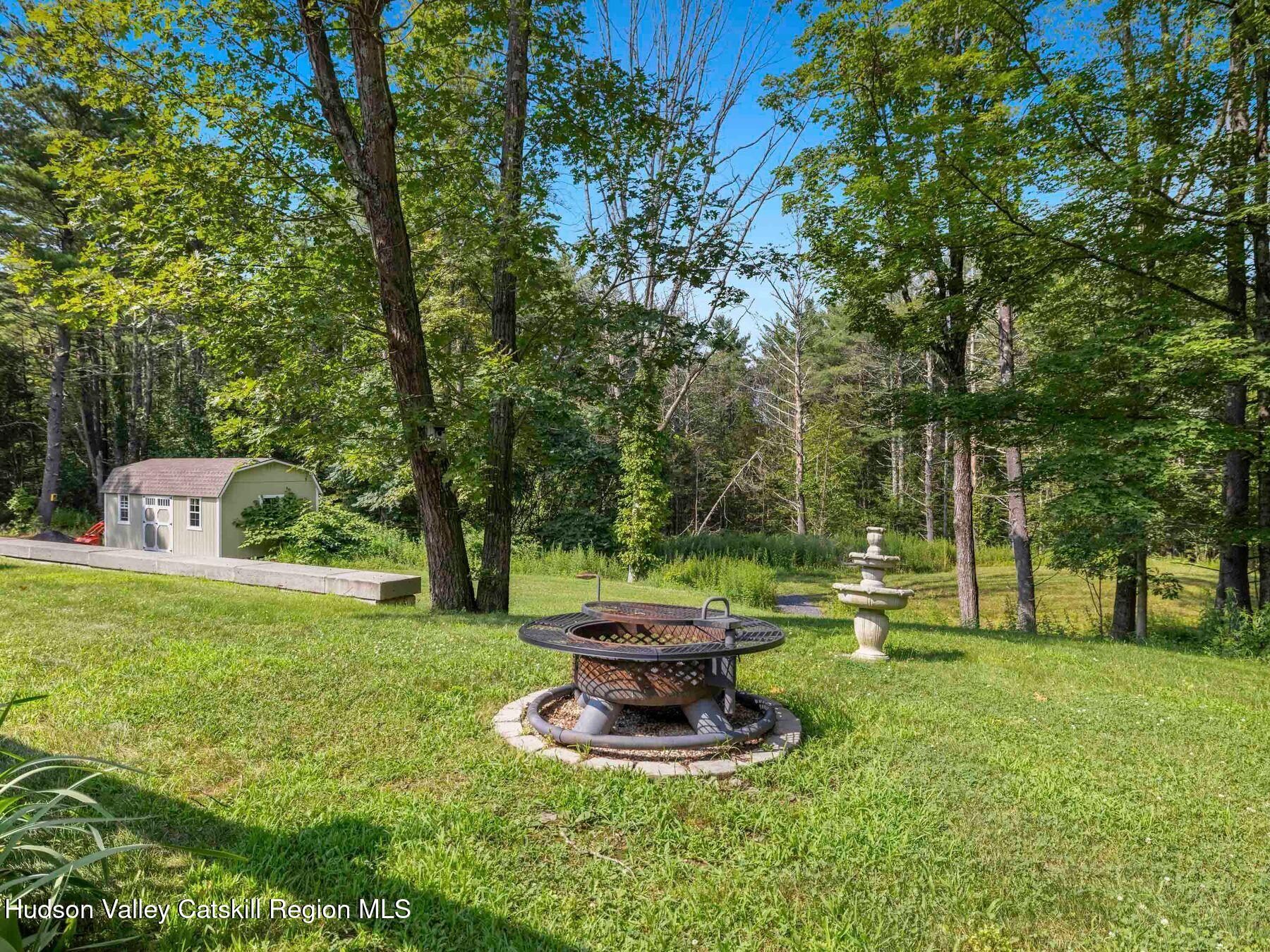 15 Pine Street Cairo, NY 12413 - Photo 44 of 46 a view of a fire pit in a yard with large trees
