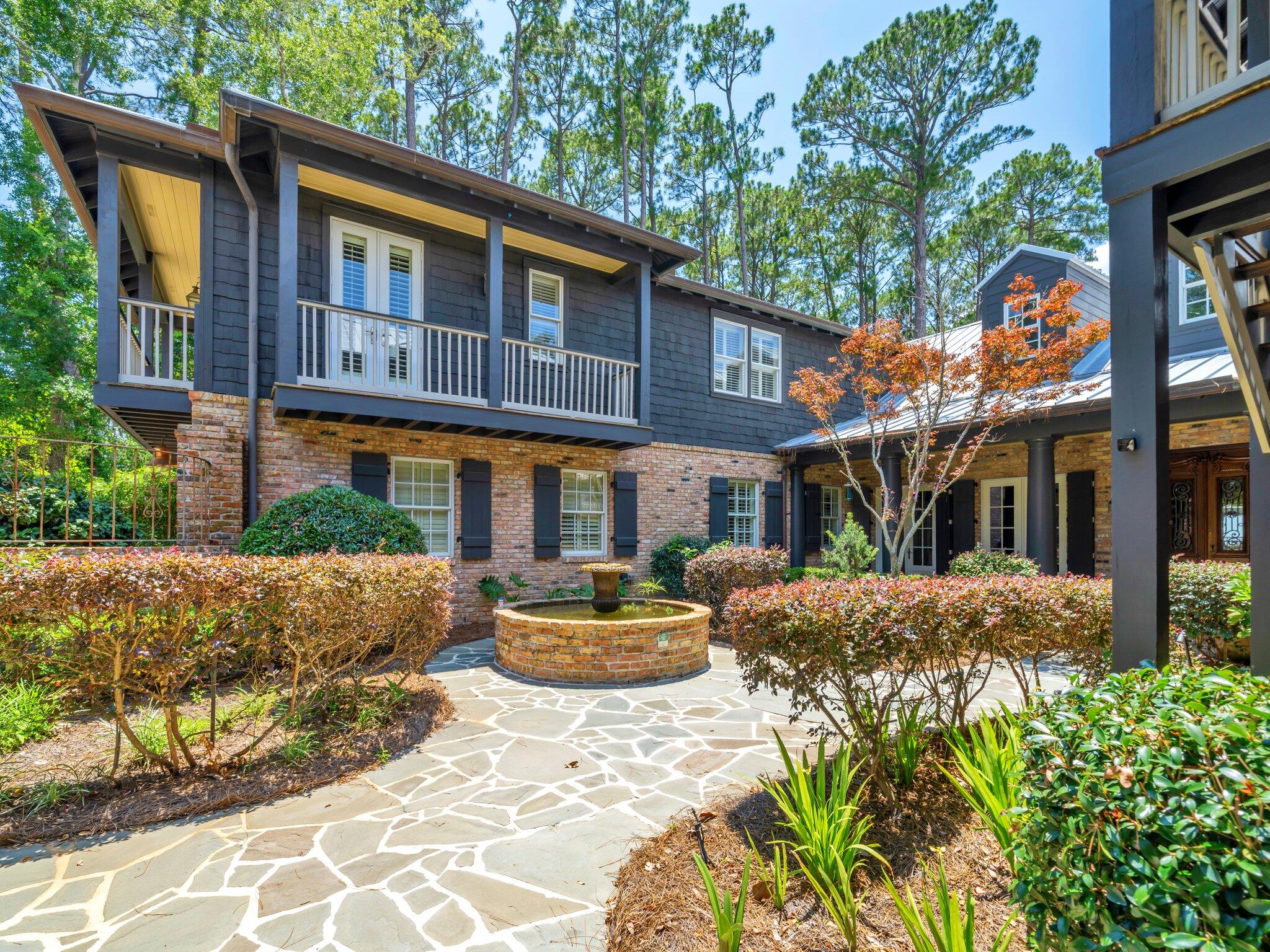389 Driftwood Point Road Santa Rosa Beach, FL 32459 - Photo 2 of 79 a front view of a house with a yard and a table