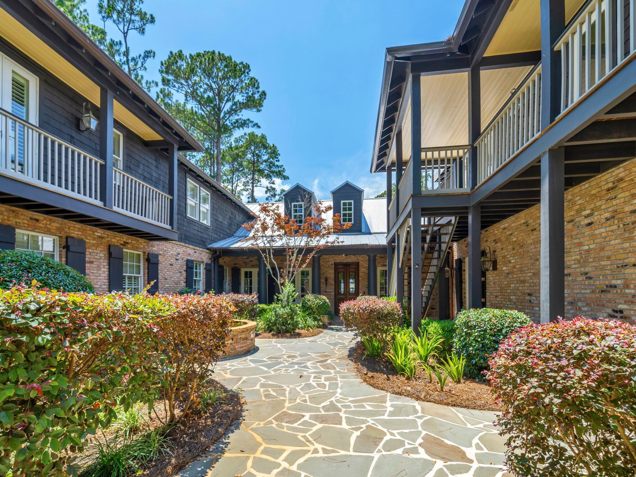 389 Driftwood Point Road Santa Rosa Beach, FL 32459 - Photo 8 of 79 a front view of a building with a garden
