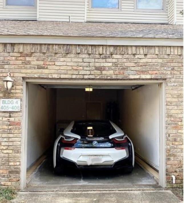 7340 Skillman Street, Unit 405 Dallas, TX 75231 - Photo 12 of 18 Enclosed garage parking featuring an overhead light fixture and concrete flooring