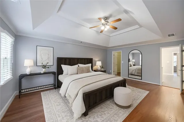 a bedroom with bed and a chandelier