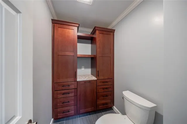 a bathroom with a toilet and vanity
