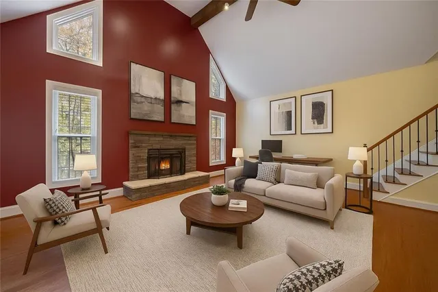 a living room with furniture a rug and a fireplace