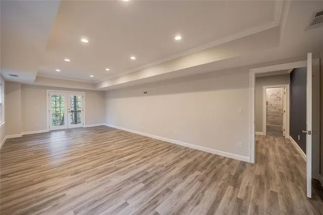a view of empty room with wooden floor