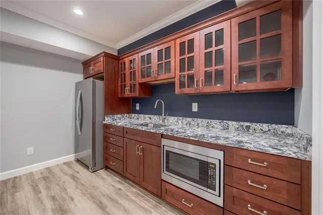 a kitchen with stainless steel appliances granite countertop a stove and a refrigerator