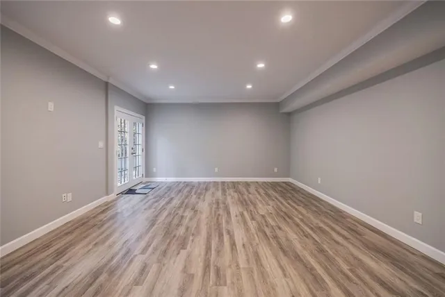 a view of empty room with wooden floor