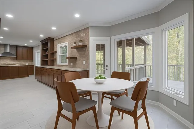 a dining room with furniture and window