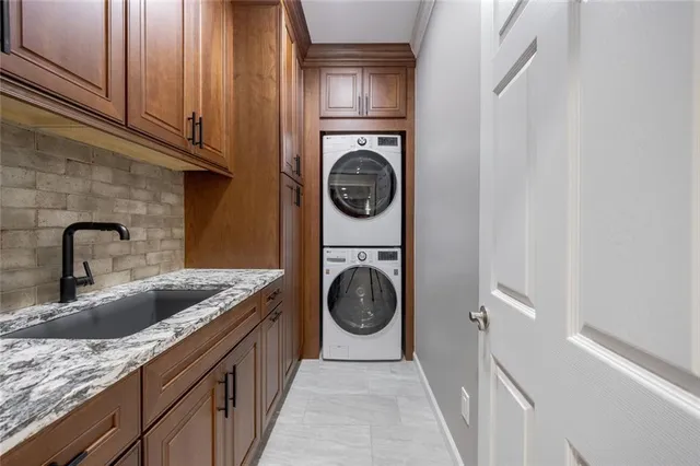 a utility room with sink dryer and washer
