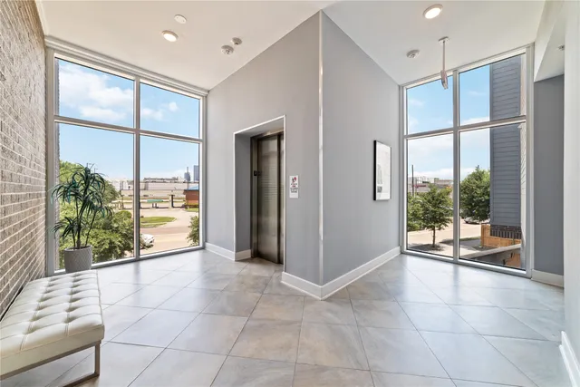 a kitchen with kitchen island a counter top space stainless steel appliances and a window