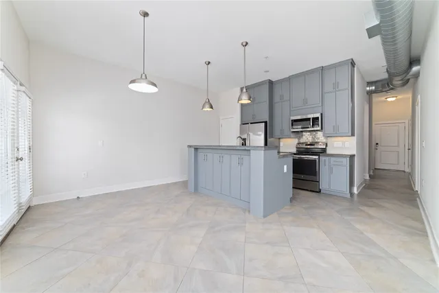 a kitchen with stainless steel appliances granite countertop a refrigerator sink and stove