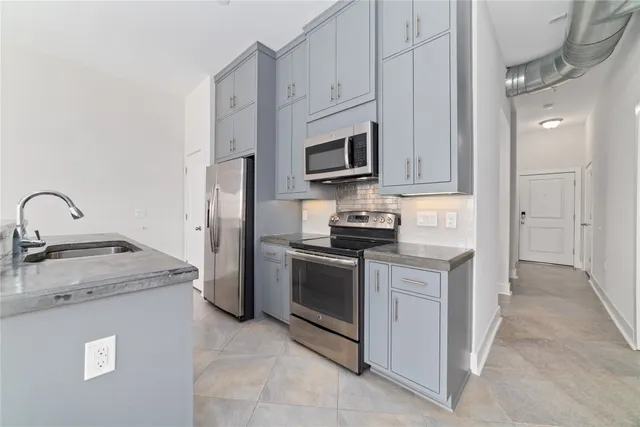 a kitchen with kitchen island white cabinets and window