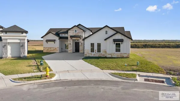 a view of a house with a swimming pool and a yard