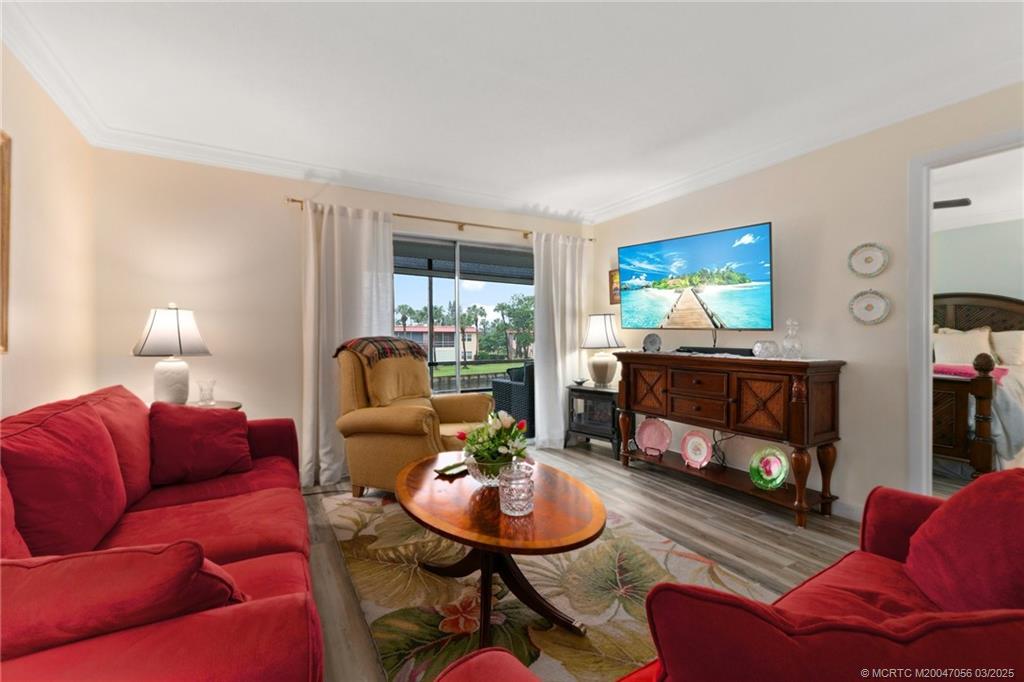 1985 Southwest Palm City Road, Unit 44I Stuart, FL 34994 - Photo 14 of 31 a living room with furniture and a fireplace