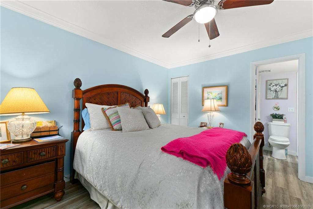 1985 Southwest Palm City Road, Unit 44I Stuart, FL 34994 - Photo 17 of 31 a bedroom with a bed and a chandelier