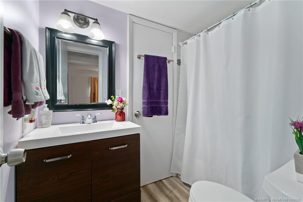 1985 Southwest Palm City Road, Unit 44I Stuart, FL 34994 - Photo 18 of 31 a bathroom with a sink vanity mirror and toilet