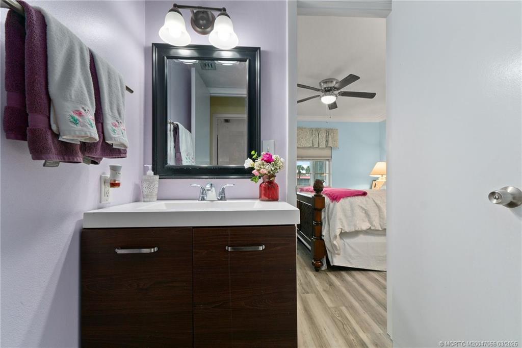 1985 Southwest Palm City Road, Unit 44I Stuart, FL 34994 - Photo 19 of 31 a bathroom with a sink vanity and mirror