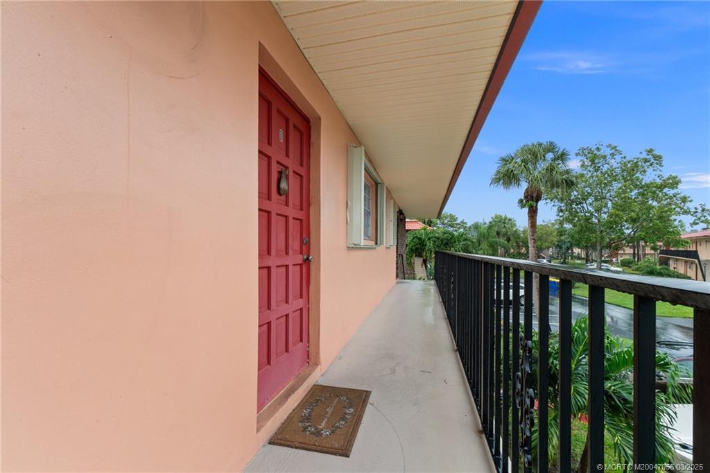 1985 Southwest Palm City Road, Unit 44I Stuart, FL 34994 - Photo 6 of 31 a view of a balcony with wooden floor and stairs