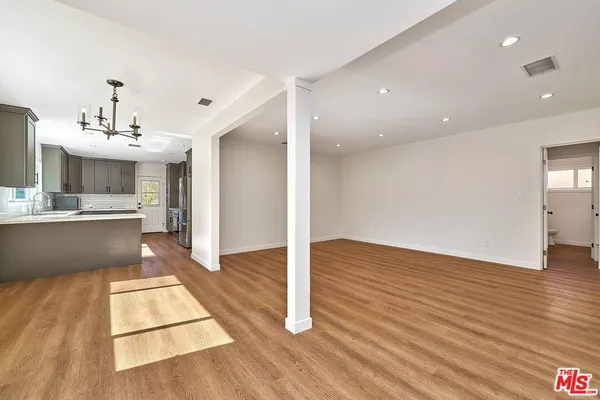 a view of kitchen with cabinets and wooden floor