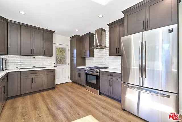 a kitchen with stainless steel appliances granite countertop a sink and a stove