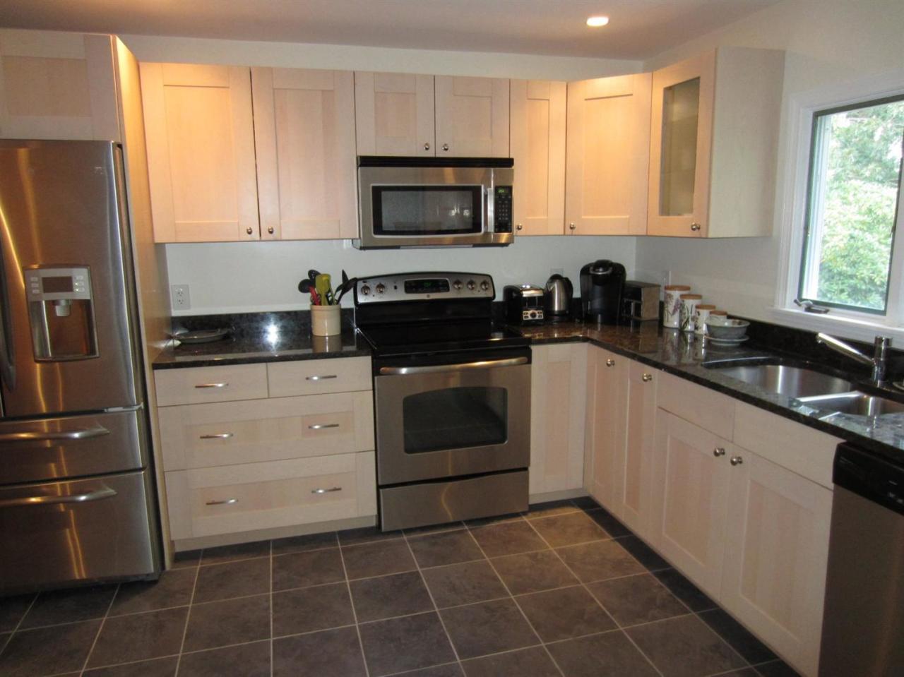83 Potonumecot Road Chatham, MA 02633 - Photo 8 of 34 a kitchen with a sink a stove and a refrigerator