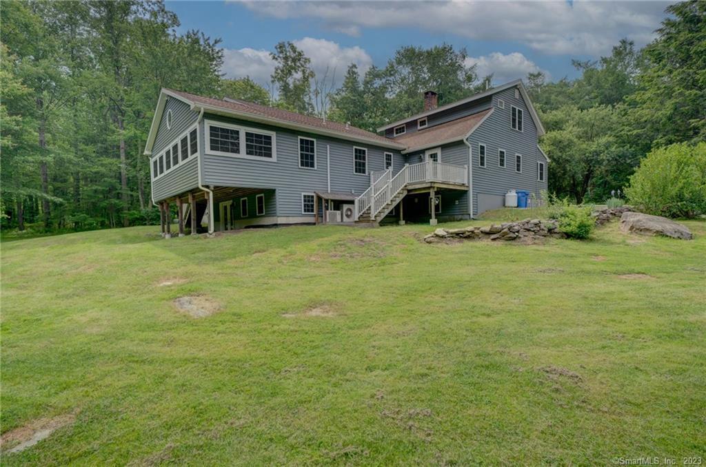 a backyard of a house with table and chairs