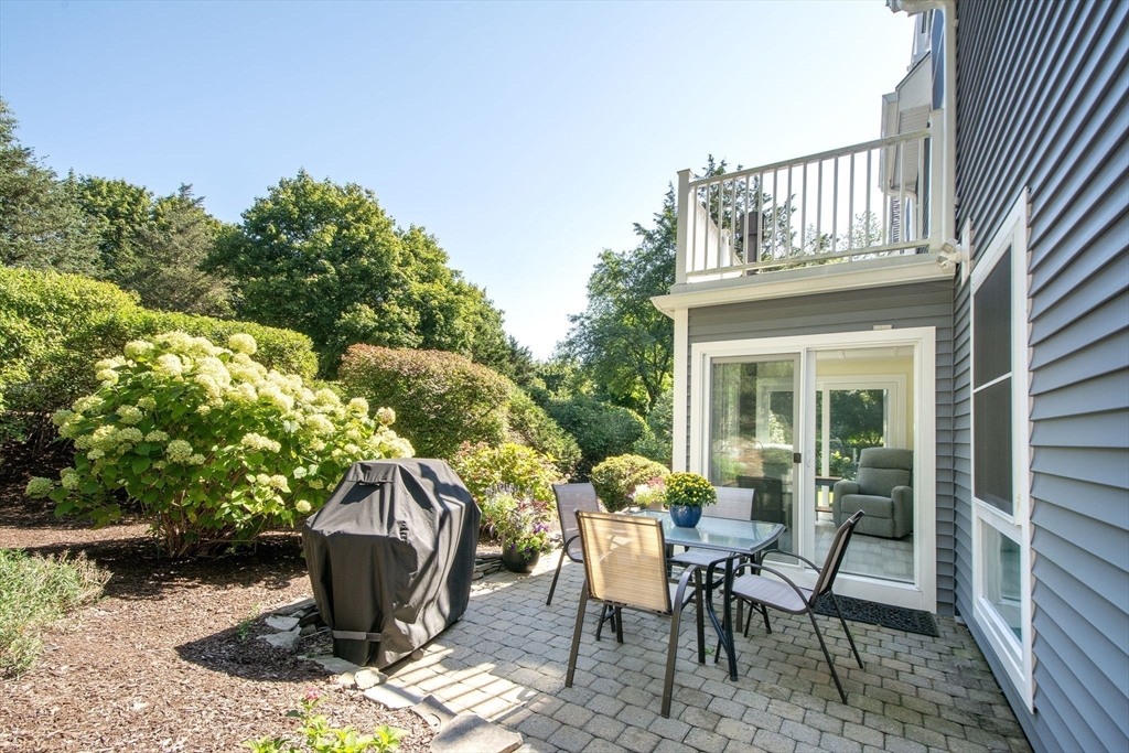 1 Gatehouse Lane, Unit 1 Hull, MA 02045 - Photo 11 of 42 a view of a patio with table and chairs and potted plants