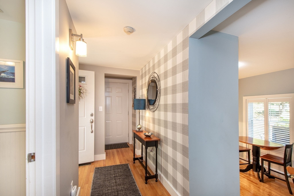 1 Gatehouse Lane, Unit 1 Hull, MA 02045 - Photo 21 of 42 a view of hallway with wooden floor and chair
