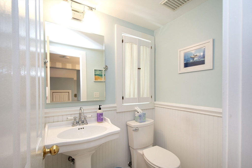 1 Gatehouse Lane, Unit 1 Hull, MA 02045 - Photo 23 of 42 a bathroom with a toilet sink and mirror