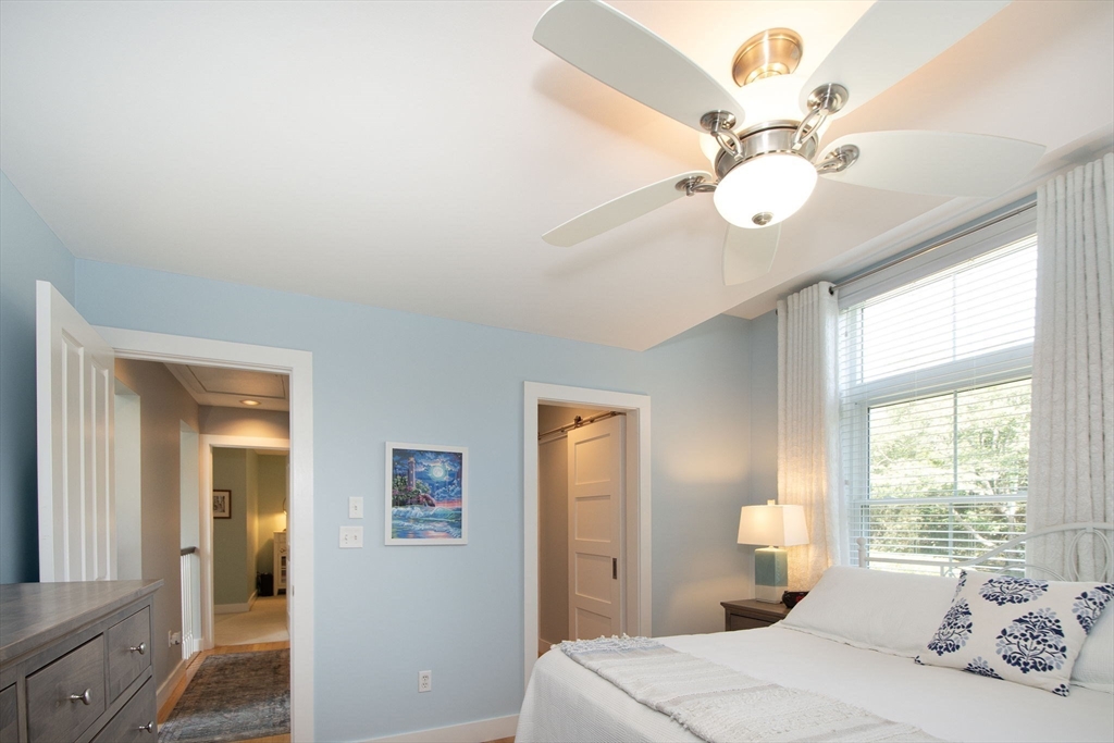 1 Gatehouse Lane, Unit 1 Hull, MA 02045 - Photo 26 of 42 a bedroom with a bed and a chandelier