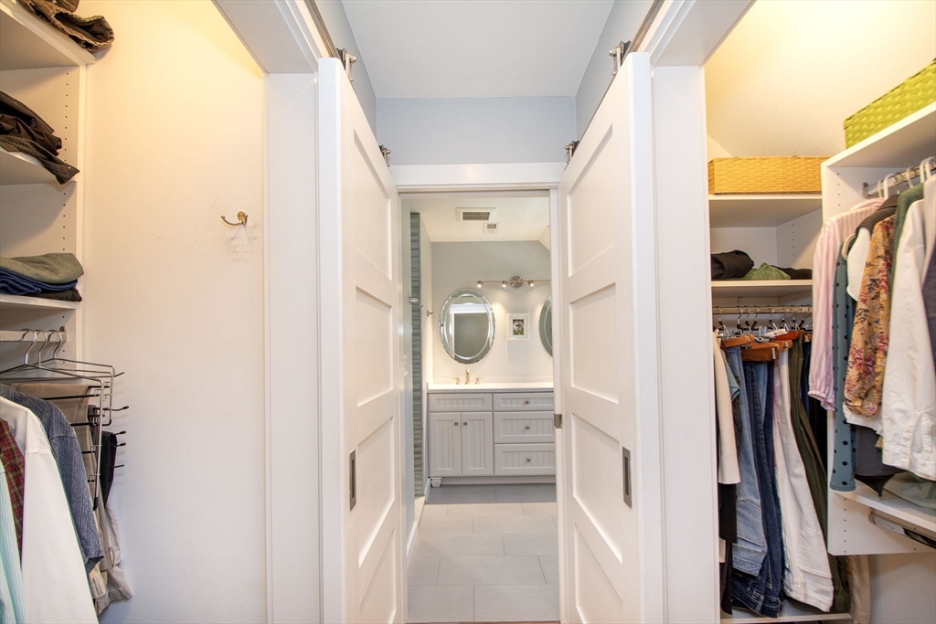 1 Gatehouse Lane, Unit 1 Hull, MA 02045 - Photo 27 of 42 a bathroom with a walk in closet and mirror