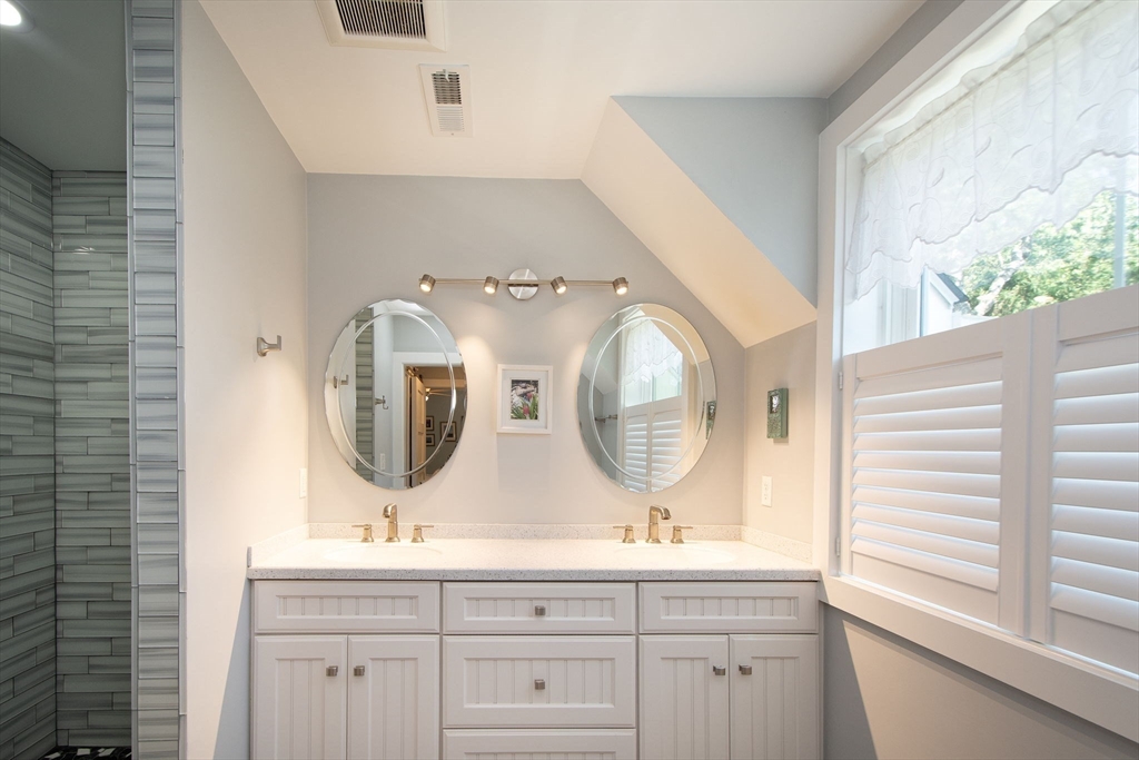 1 Gatehouse Lane, Unit 1 Hull, MA 02045 - Photo 28 of 42 a bathroom with a double vanity sink and mirror
